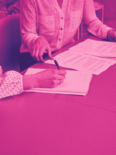 Two people at the table sign a contract.